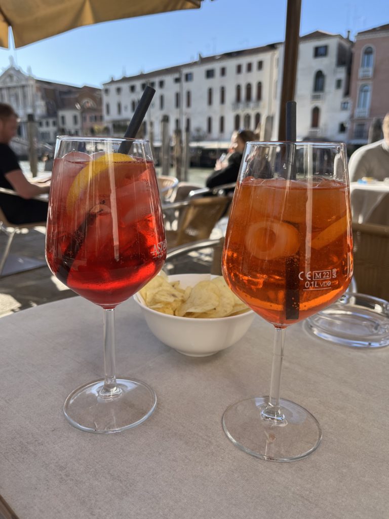 Two wine glasses of Sprizzino at an outdoor table at Hotel Canal Grande in Venice